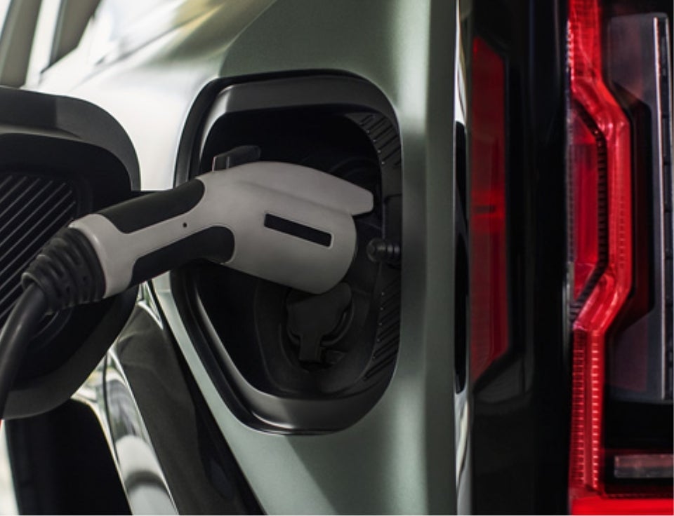 Close up of charging port with charger plugged in on a GMC Hummer EV SUV - Cooper GMC in ANNISTON AL